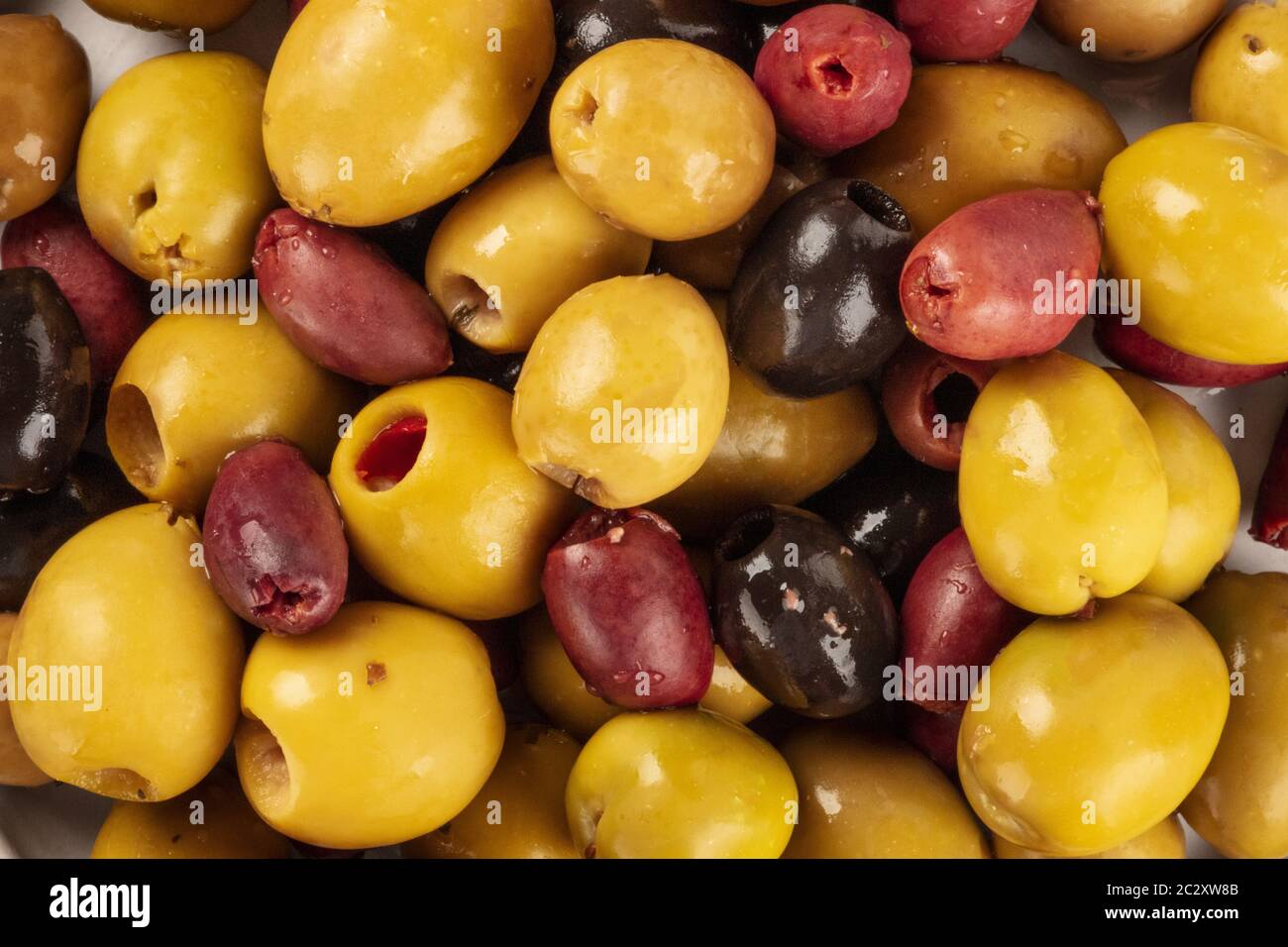 Olives background texture. Black, green and brown olives, an assortment, shot from above Stock Photo