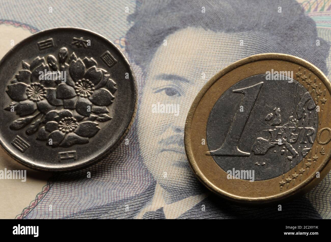 Japanese banknote with coin and one euro Stock Photo