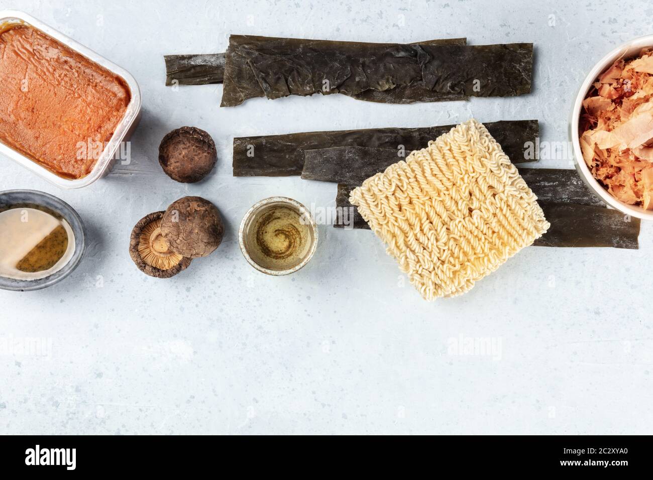 Ramen ingredients. Dried sea vegetable kelp, soba instant noodles, red miso paste, tuna flakes, shiitake mushrooms, sake, mirin, Stock Photo