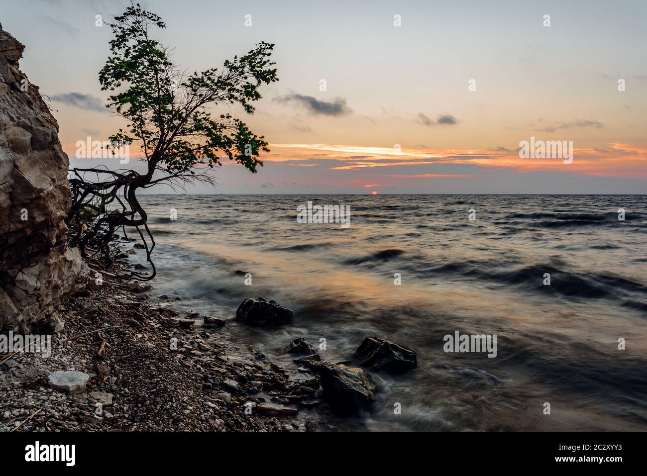 Sunrise on rocky shore hi-res stock photography and images - Alamy