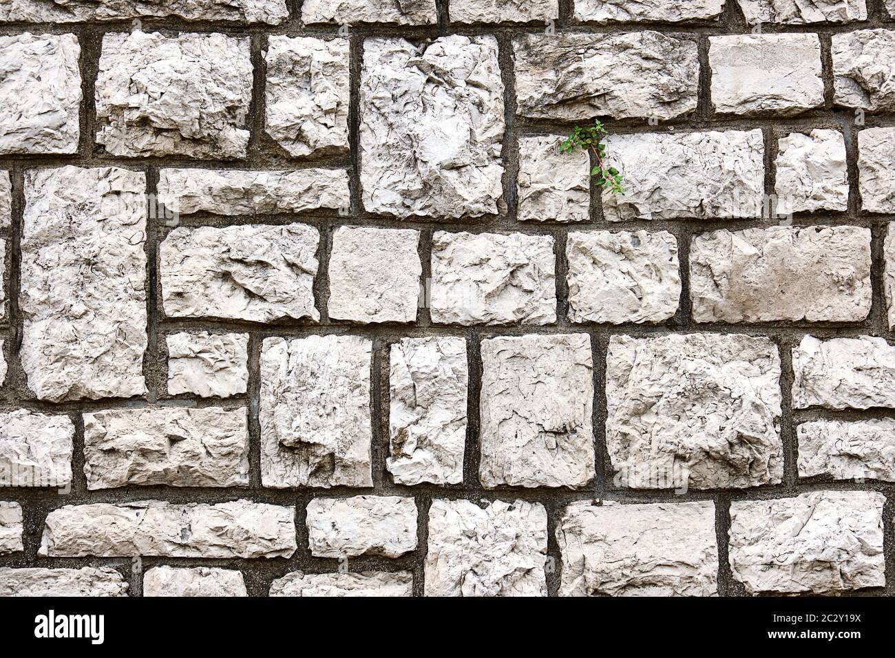 Background from a wall made of block shaped old natural stones Stock Photo