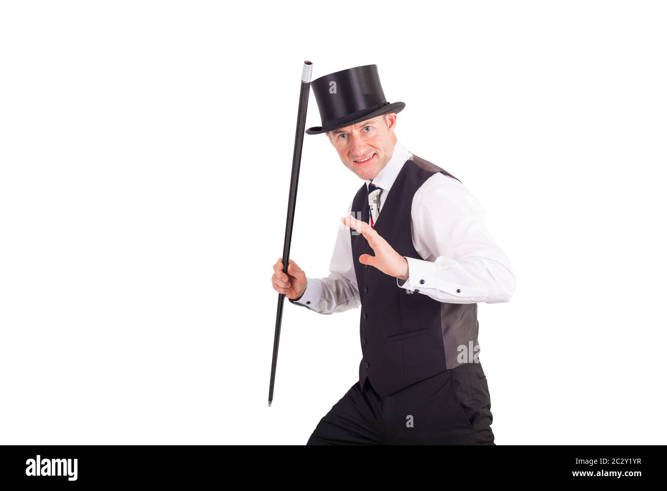 illusionist with magic stick in front of white Stock Photo - Alamy