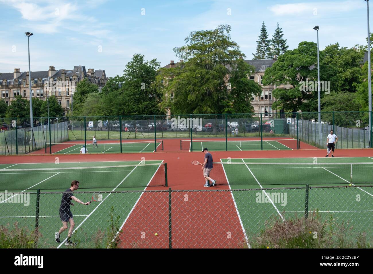 Glasgow, Scotland, UK. 18th June, 2020. People playing tennis in Queen's  Park. The Scottish Government announced today a further easing of the  coronavirus lockdown rules at the start of phase two of