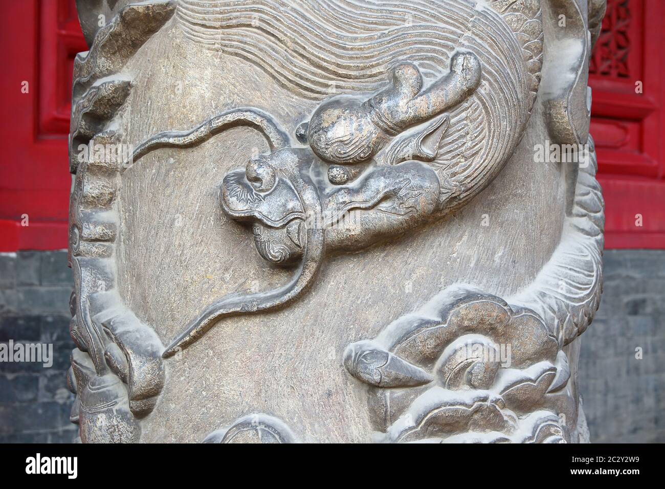 Image of a dragon head sculpted on a column. Horizontal orientation. Stock Photo