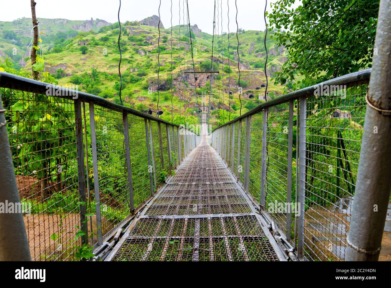 Suspension swinging bridge over the in Armenia near the cave city