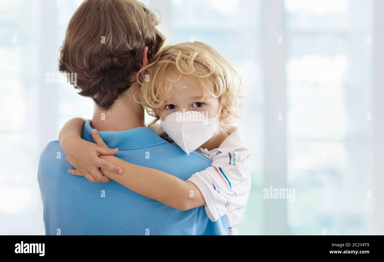 Family with kids in face mask in shopping mall or airport. Father and child wear facemask during coronavirus and flu outbreak. Virus and illness prote Stock Photo