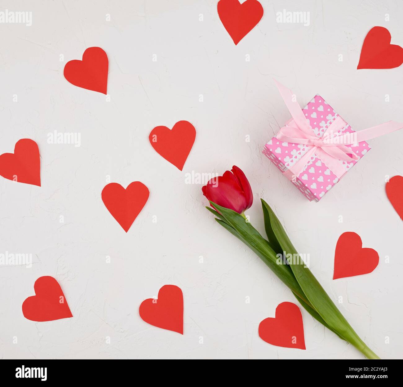 bouquet of red blooming tulips with green stems and leaves and red ...
