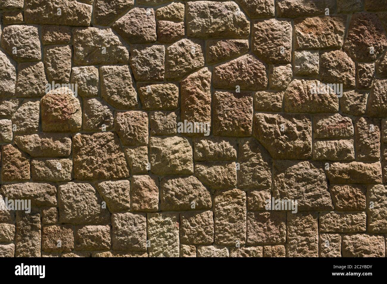 Dry stone wall texture background, in searing light. Stock Photo