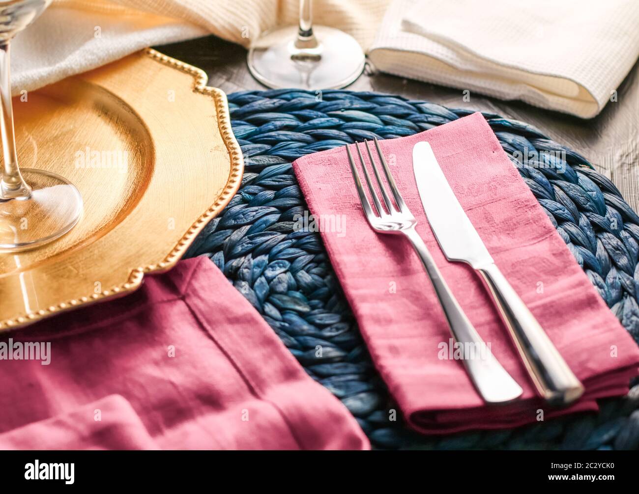 Holiday table setting with pink napkin and silver cutlery, food styling props, vintage set for wedding, event, date, party or lu Stock Photo