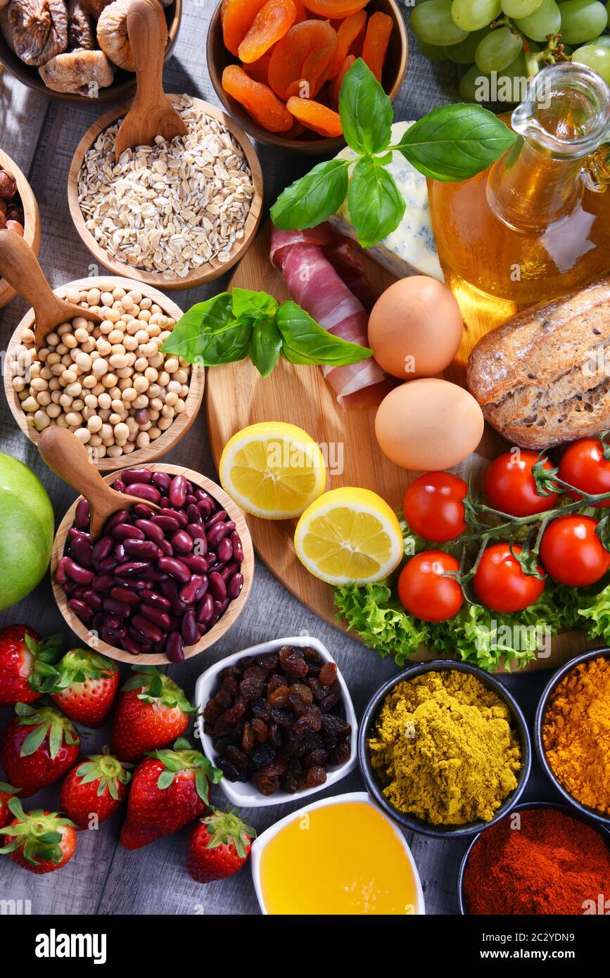 Composition with assorted organic food products on wooden kitchen table ...