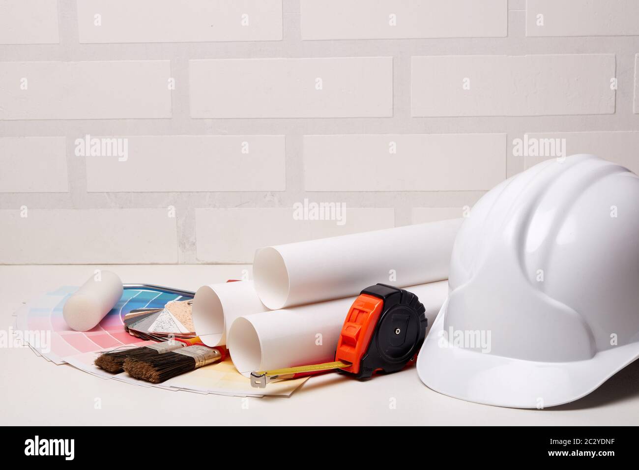 Architectural blueprints, construction hard hat, color palette guide