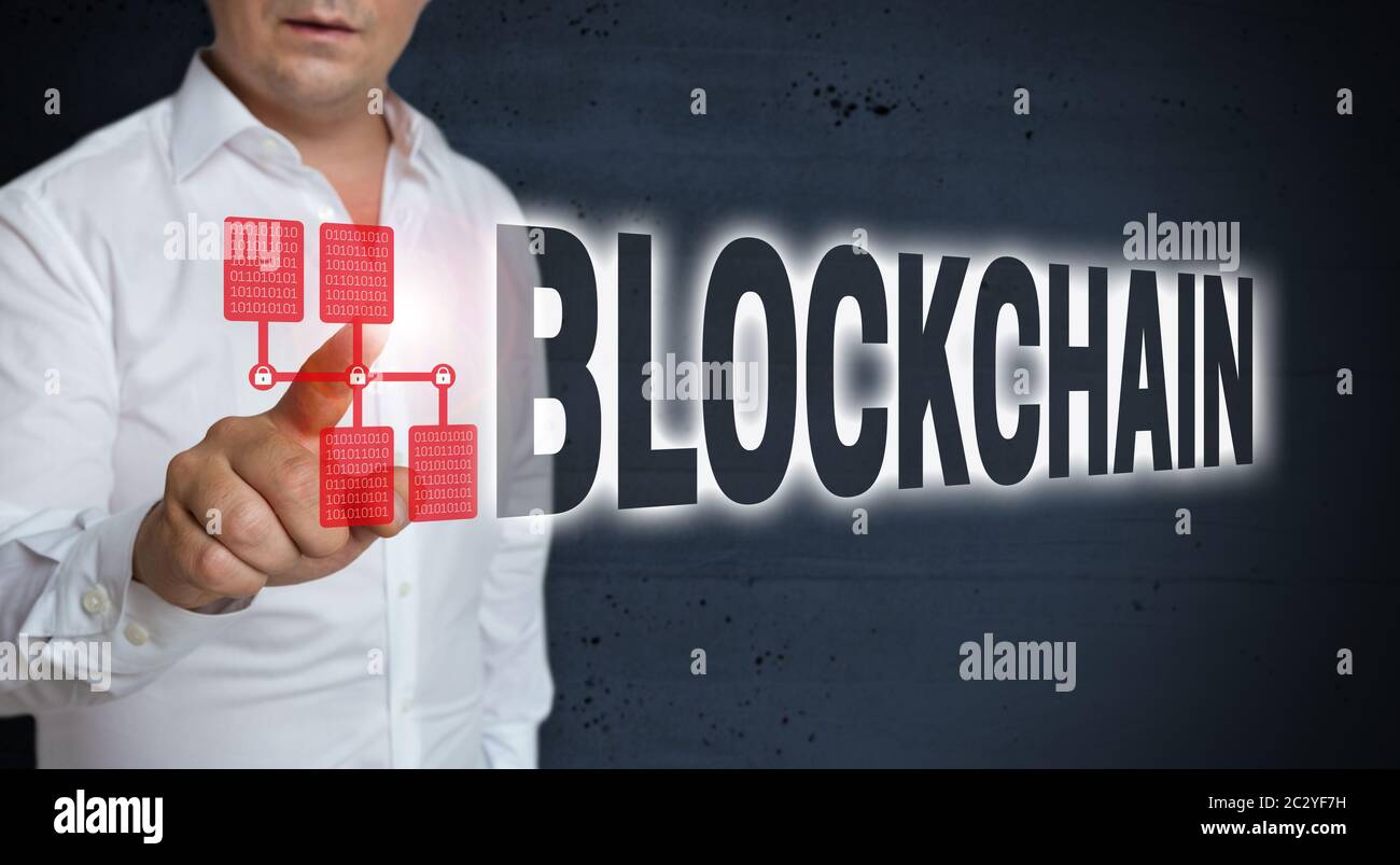 Blockchain concept touchscreen is shown by man. Stock Photo
