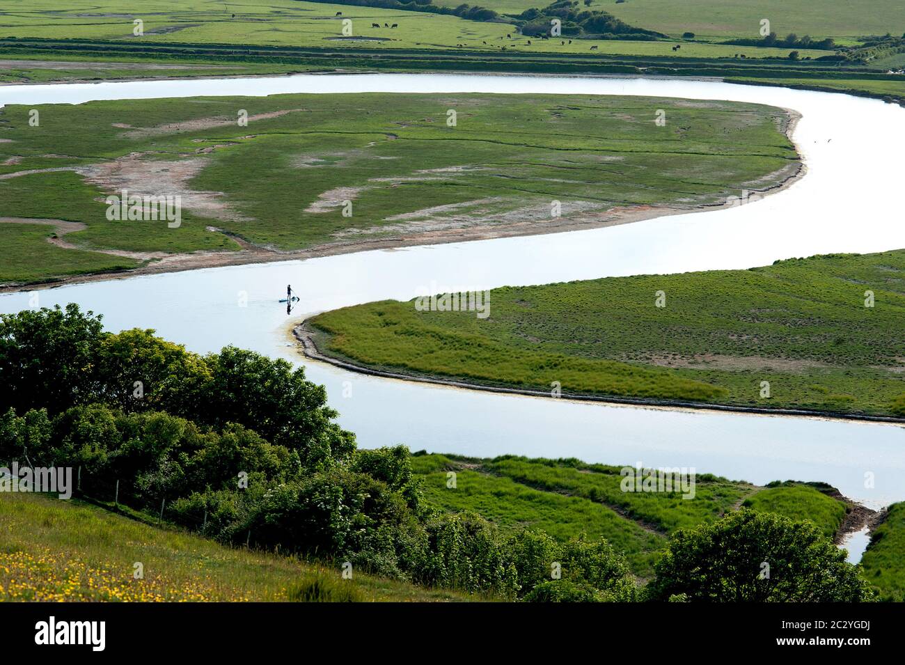 Paddle-boarders on the River Cuckmere in Sussex, England Stock Photo