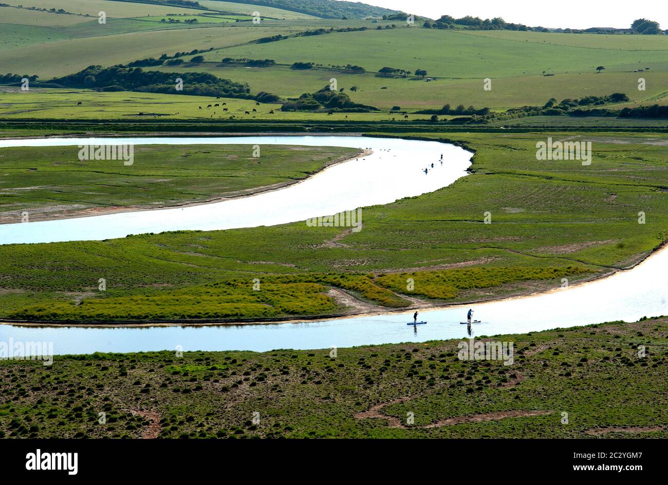 Paddle-boarders on the River Cuckmere in Sussex, England Stock Photo