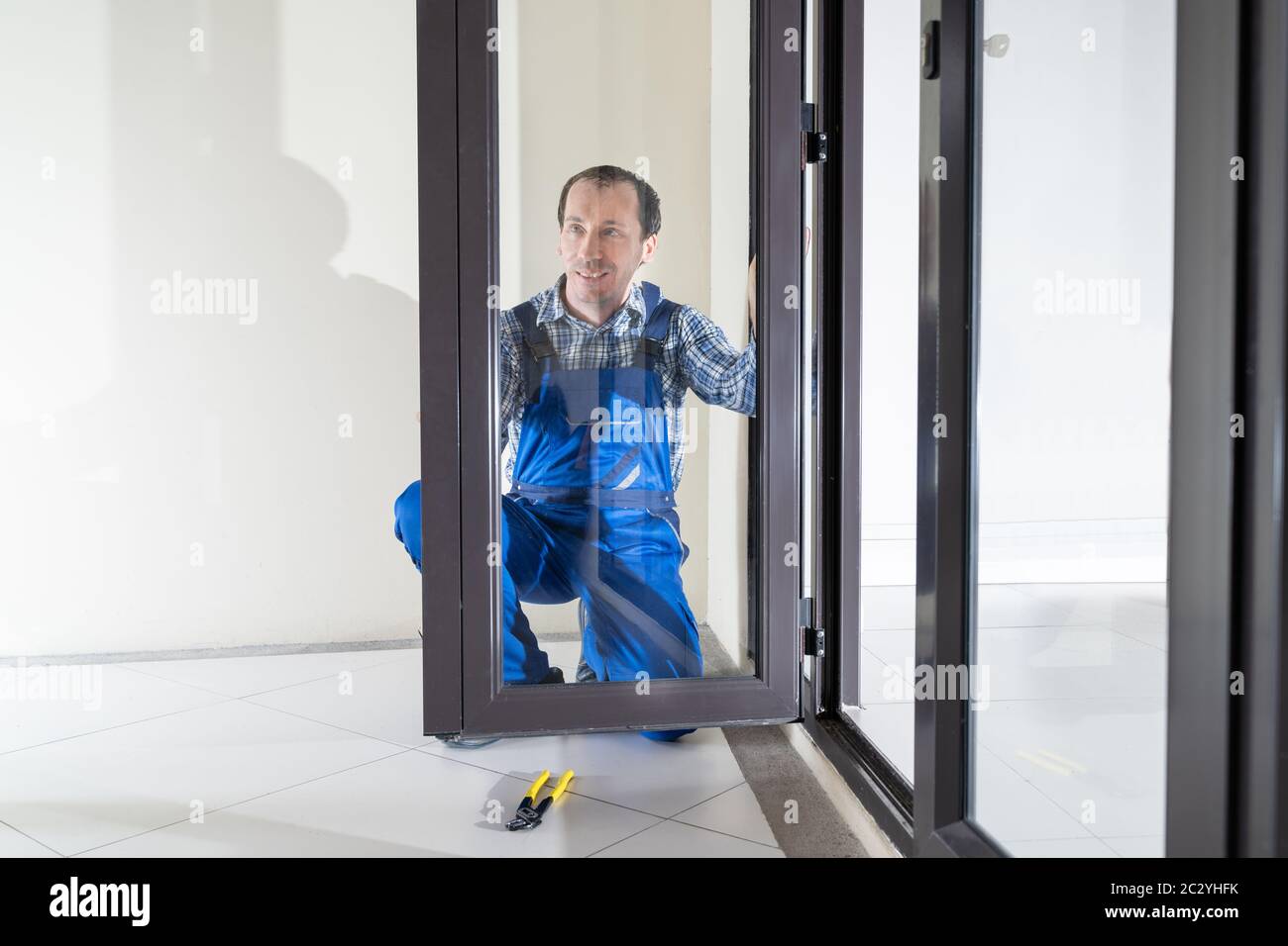 Close-up Of A Repairman's Hand Fixing Window Stock Photo - Alamy