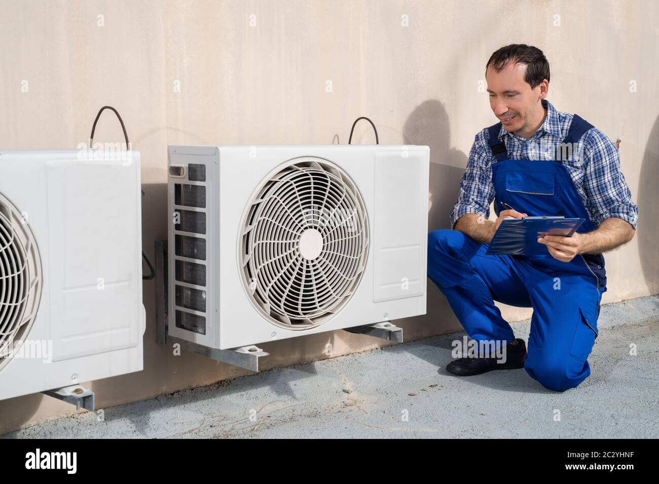 Man Doing Heating, Ventilation, And Air Conditioning Inspection Stock Photo
