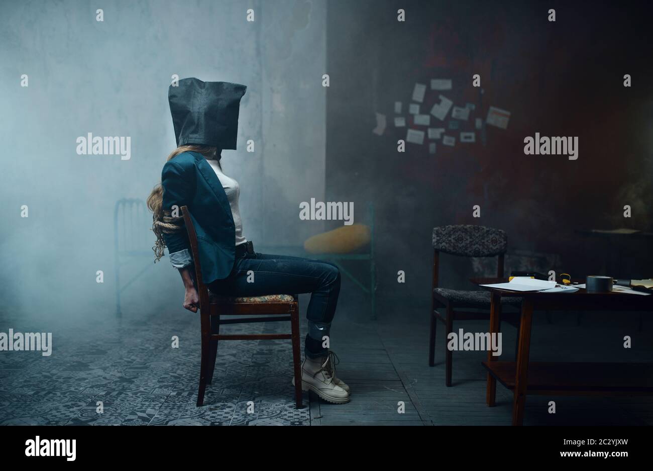 Female victim of maniac kidnapper with a bag on her head. Kidnapping is