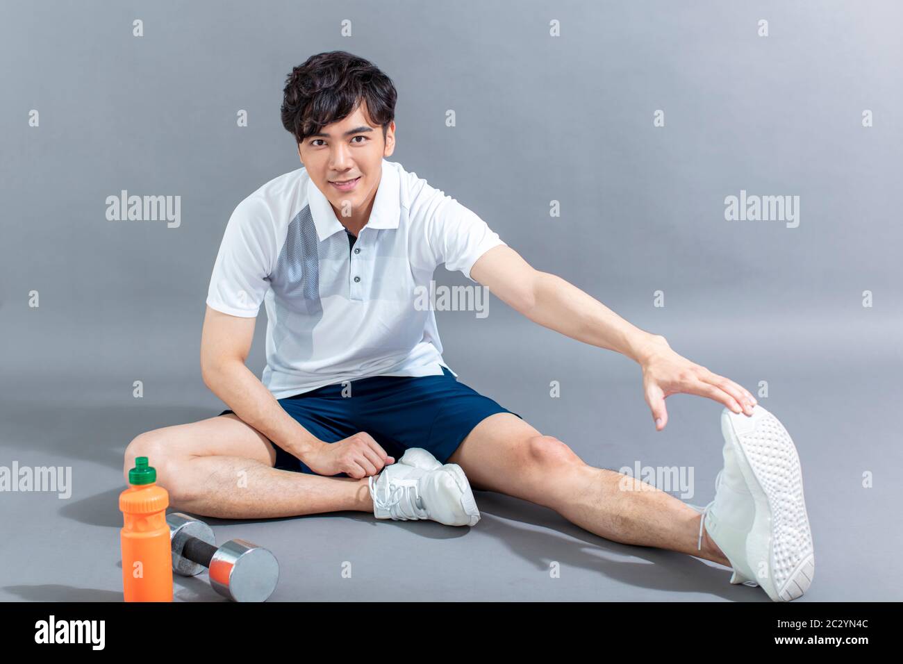 young man runner doing stretching exercise Stock Photo