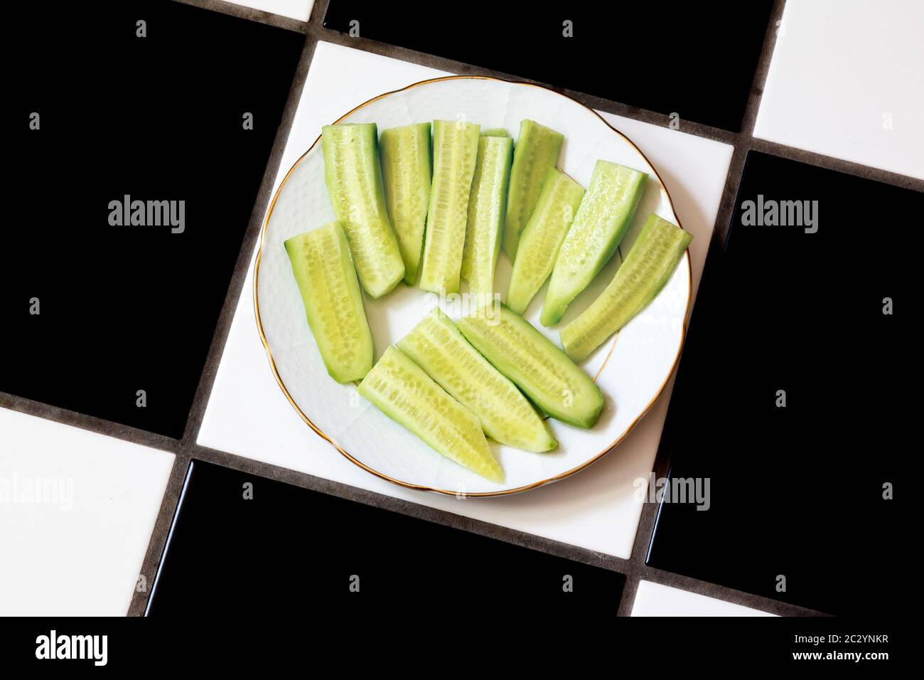 Sliced cucumber on white plate. Stock Photo