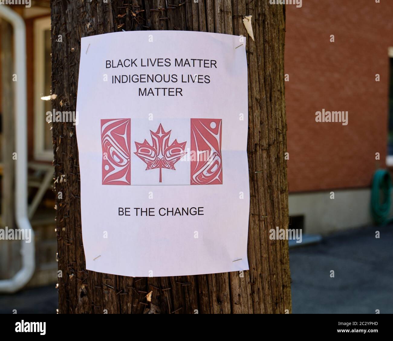 Combined "Black lives Matter" and "Indigenous Lives Matter" with Indigenous designed flag Stapled on pole in Ottawa, Canada Stock Photo