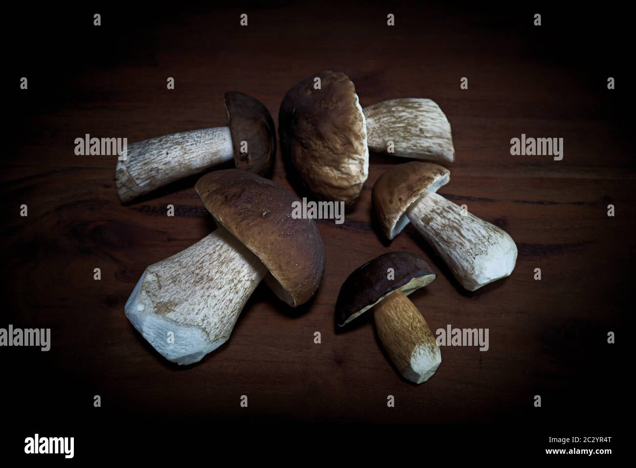 Edible mushrooms from the forest lie on a kitchen table Stock Photo