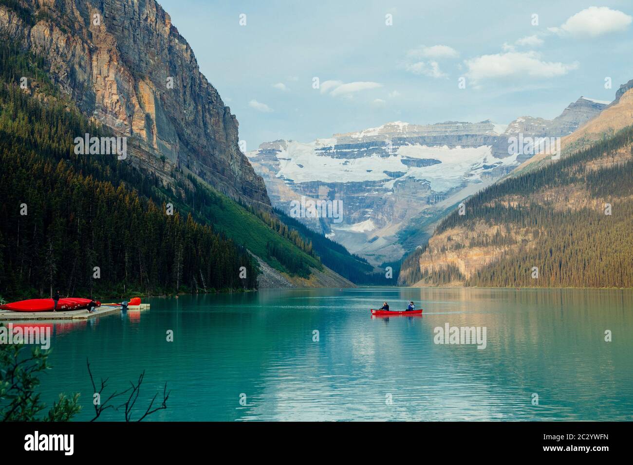 Side view of red rowboat on calm lake, Banff, Alberta, Canada Stock Photo