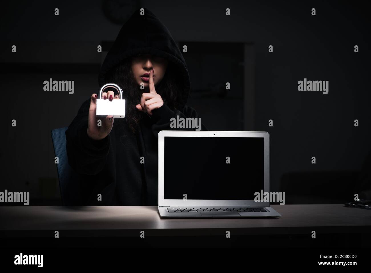 Female hacker hacking security firewall late in office Stock Photo
