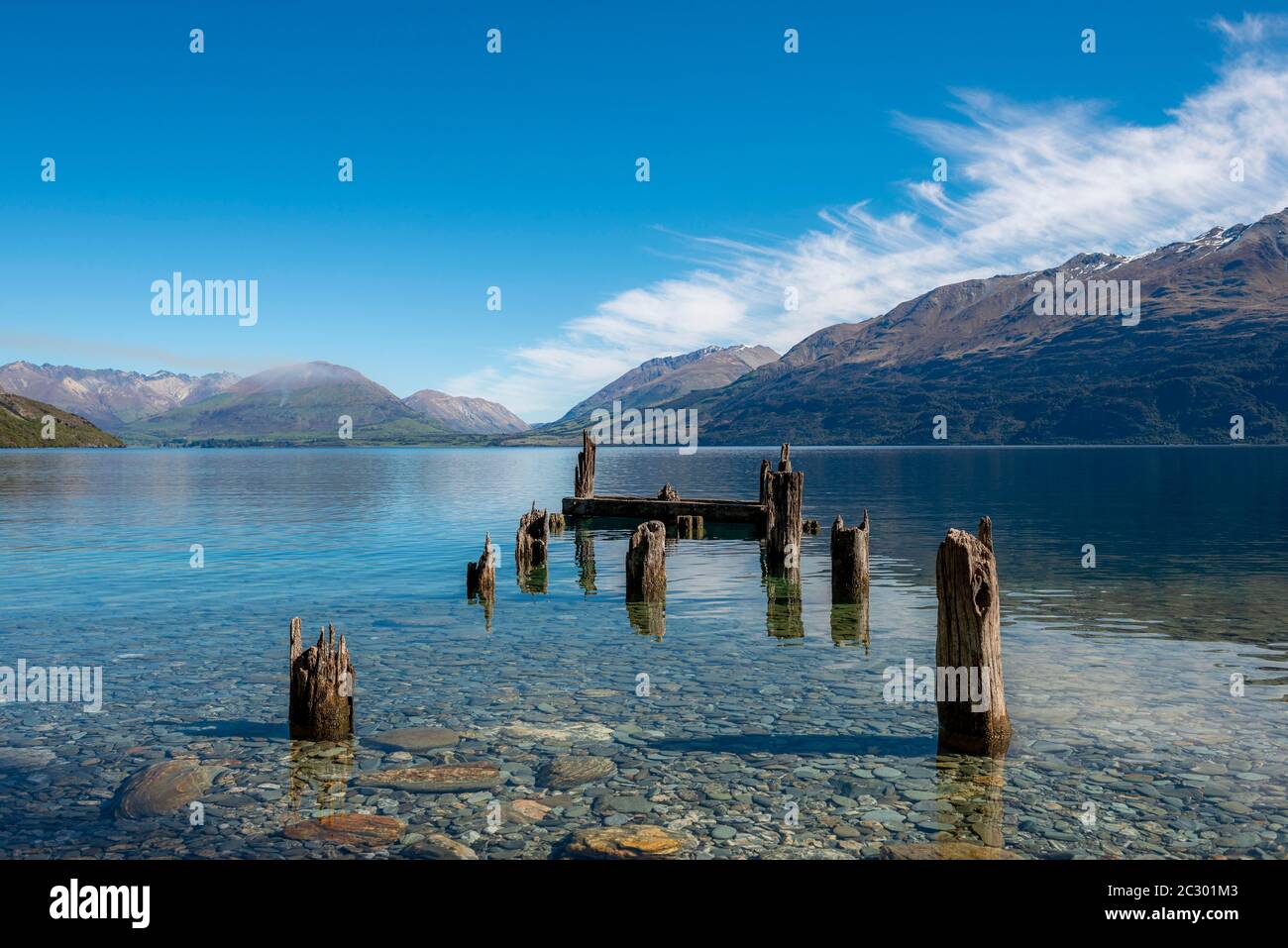 Decayed jetty, old wooden posts in Lake Wakatipu, near Glenorchy, Otago, South Island, New Zealand Stock Photo