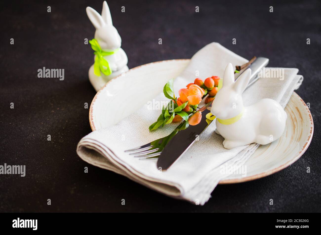 Easter table setting with spring flowering branches, cutlery and ...