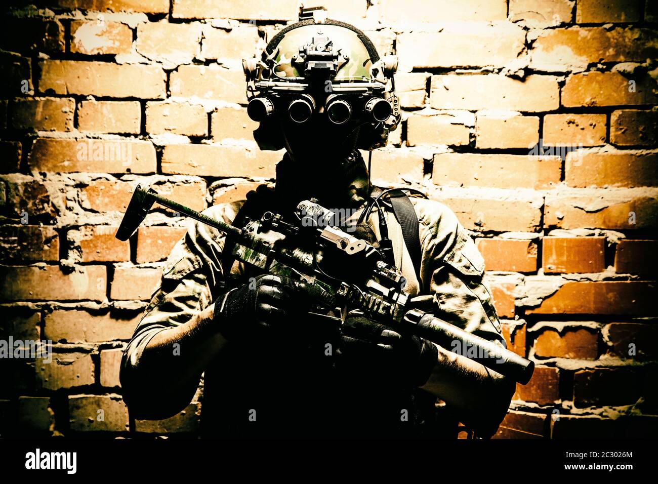 Army special forces tactical group fighter in cqb mission, using radio headset, looking through