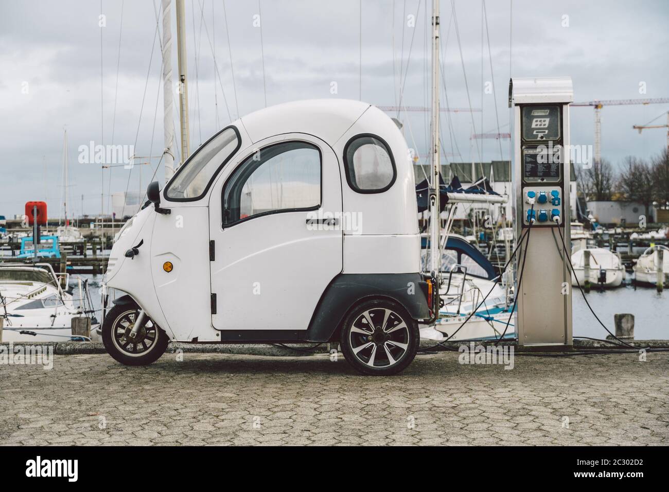 small electro car charging in street seafront in Copenhagen, Denmark