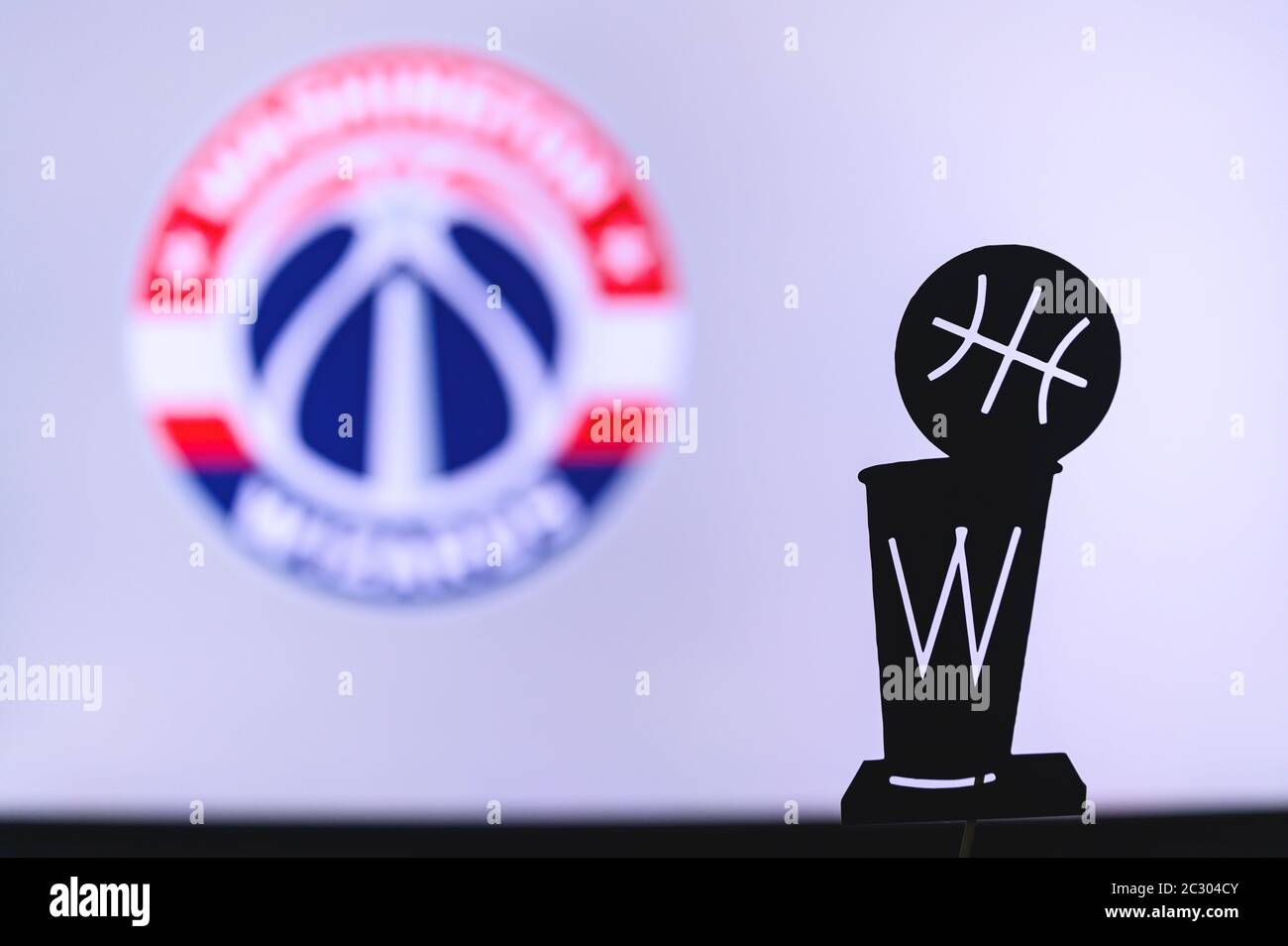 NEW YORK, USA, JUN 18, 2020: Washington Wizards Basketball club on the white screen. Silhouette of NBA trophy in foreground. Stock Photo