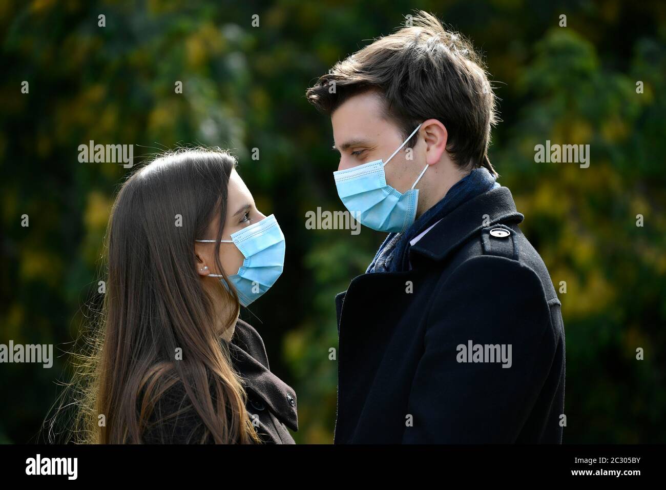 Young couple with face mask, face-to-face. Corona crisis, Karlsruhe, Baden-Wuerttemberg, Germany Stock Photo