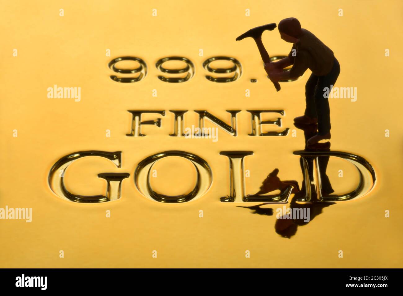 Symbolic picture, gold digger on gold bar fine gold 999, 9 degrees of purity, Germany Stock Photo