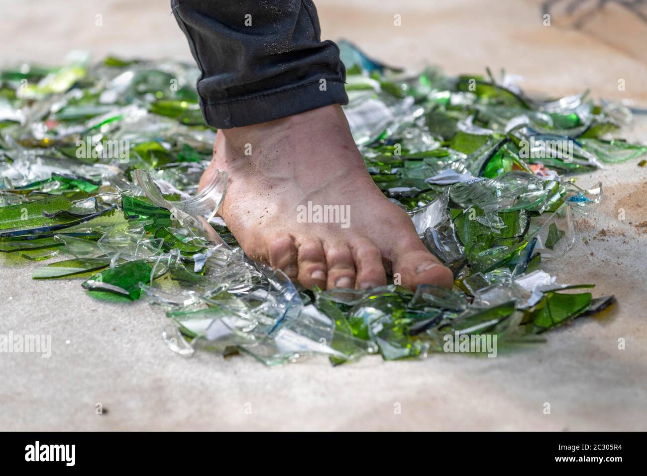 Fakir with foot on broken glass, Rinteln, Germany Stock Photo