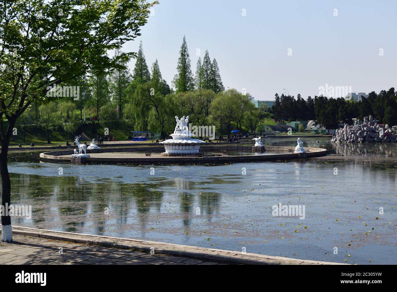 Pyongyang, North Korea - May 2, 2019: View of an Pyongyang outskirts, park with a pond and a fountain with characters from children's fairy tales Stock Photo