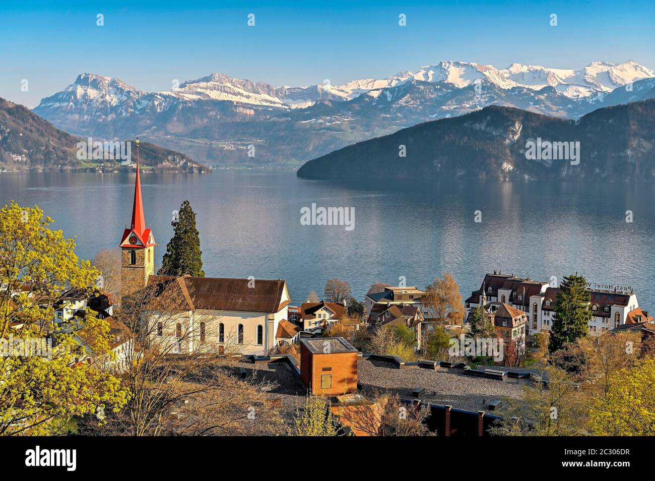 Holiday destination on Lake Lucerne with the parish church of St. Mary behind the snow-covered Alps, Weggis, Canton Lucerne, Switzerland Stock Photo