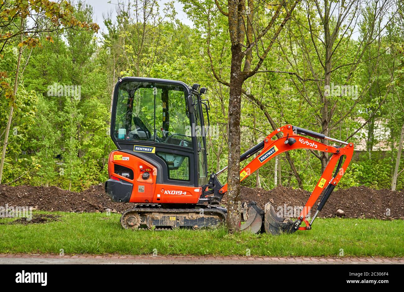 Small excavator left for the weekend. Stock Photo