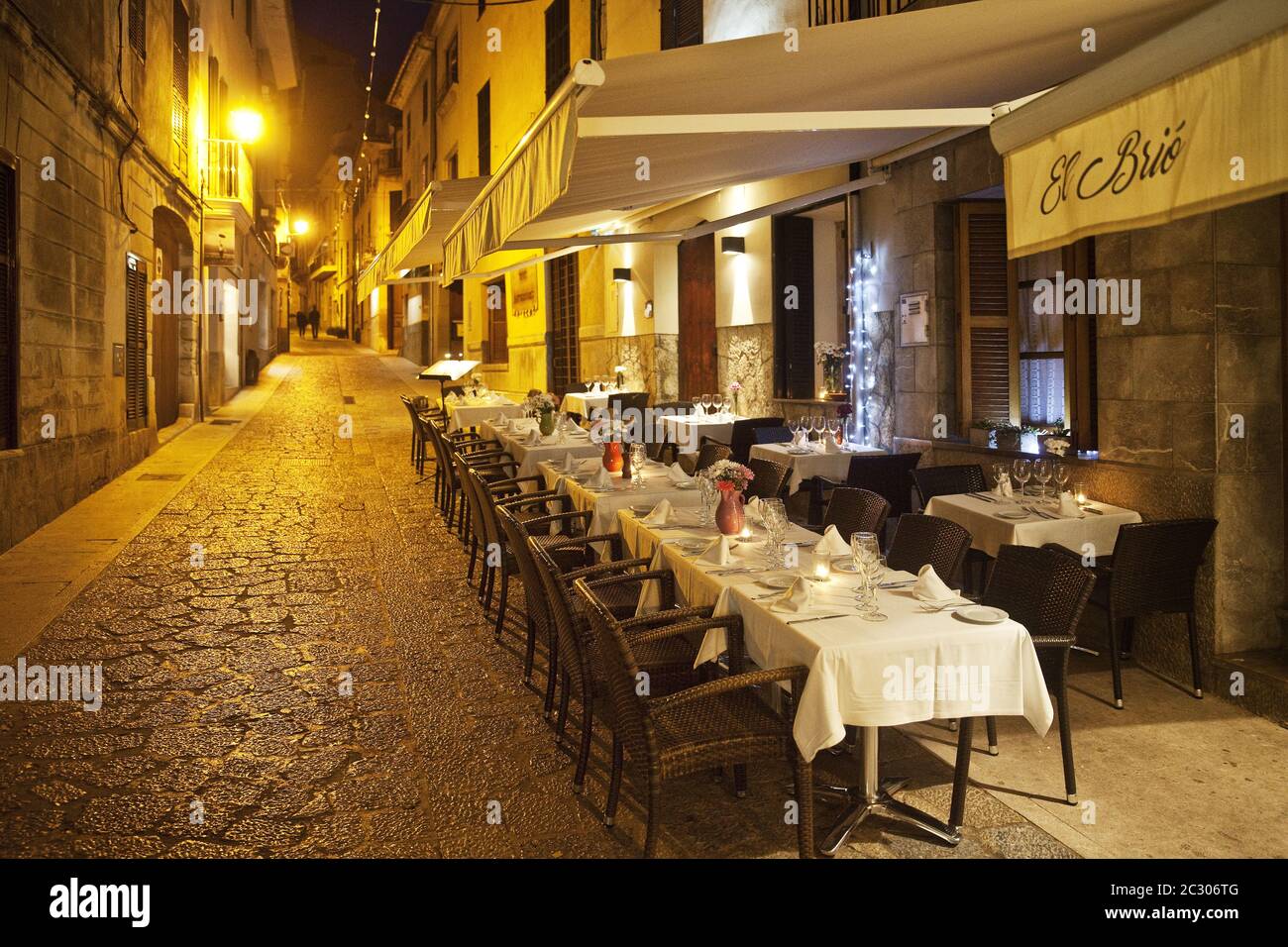 Outdoor dining in an alley in the old town in the evening, Pollenca, Mallorca, Spain, Europe Stock Photo