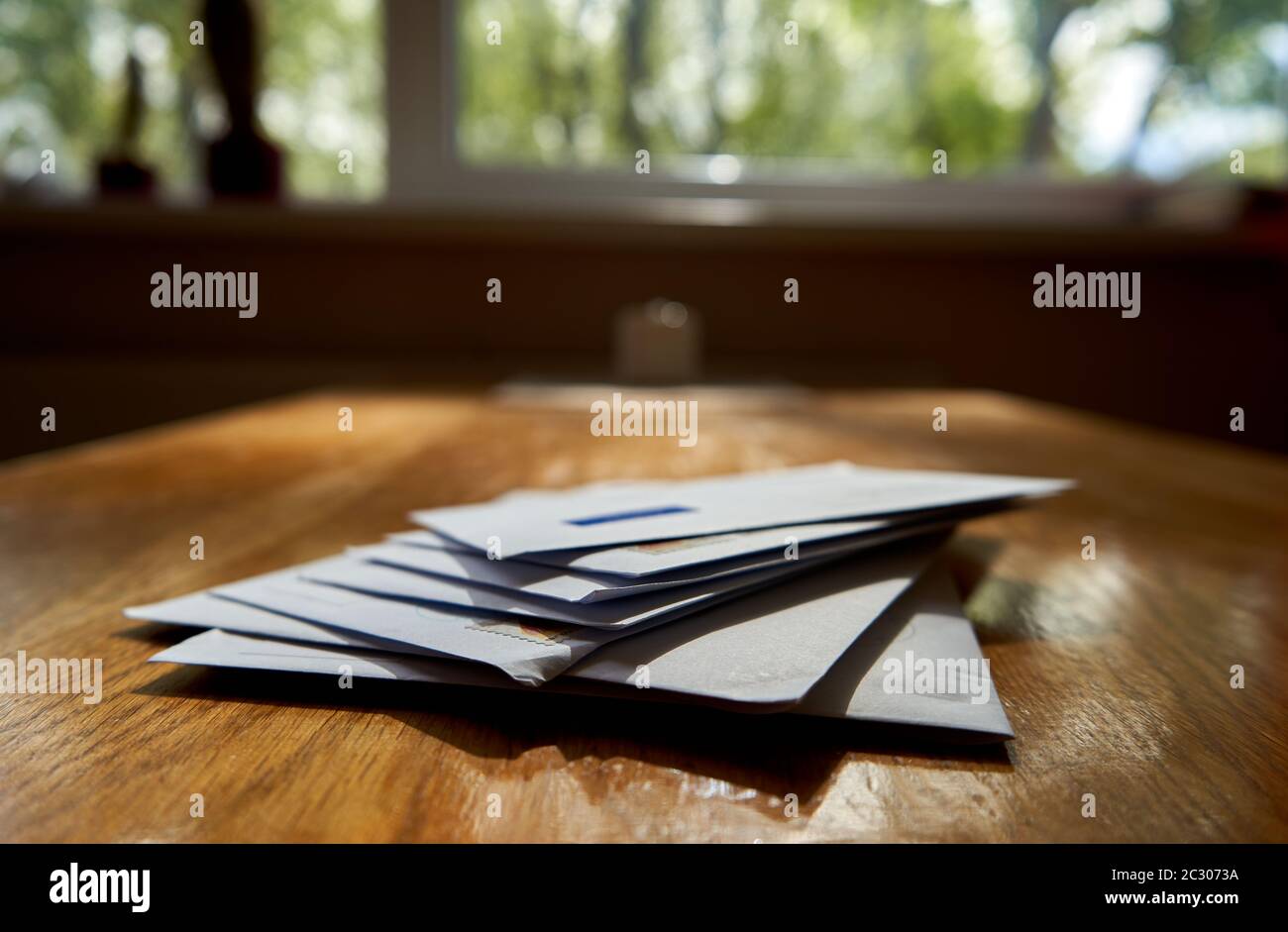 Envelopes on the wooden table during sunny day Stock Photo