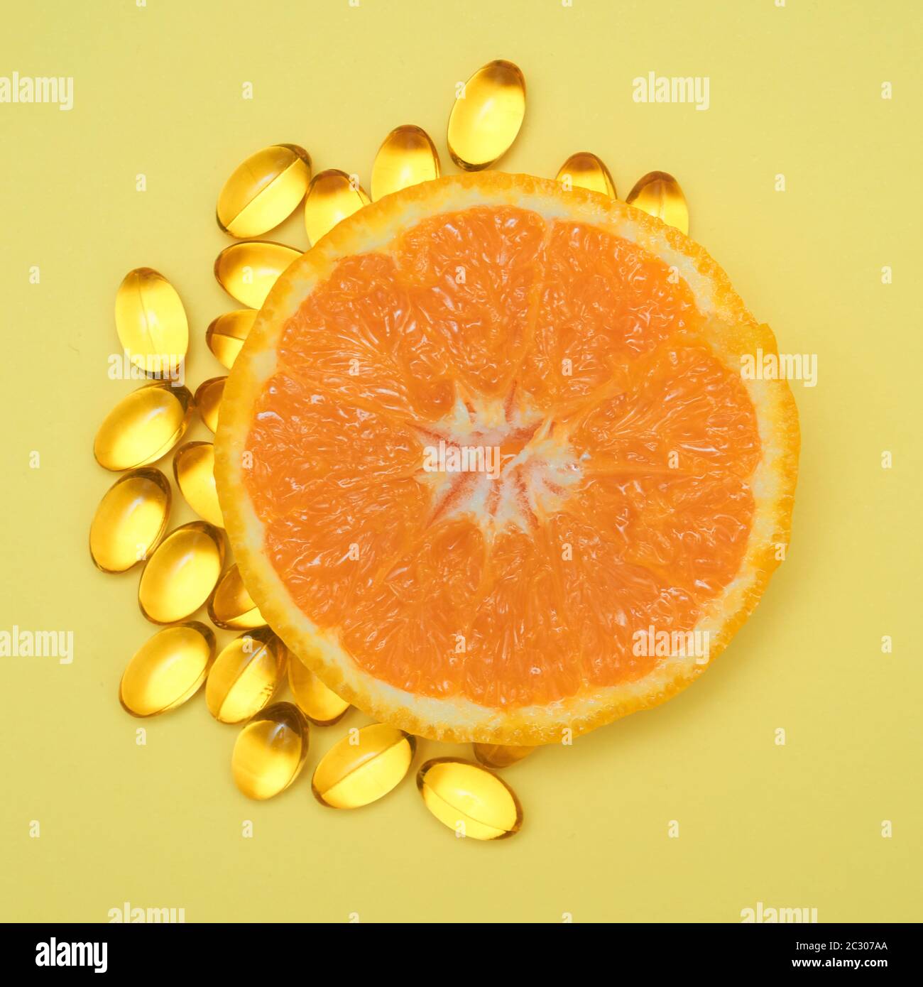 Vitamin C pills around an orange. Healthy concept Stock Photo Alamy