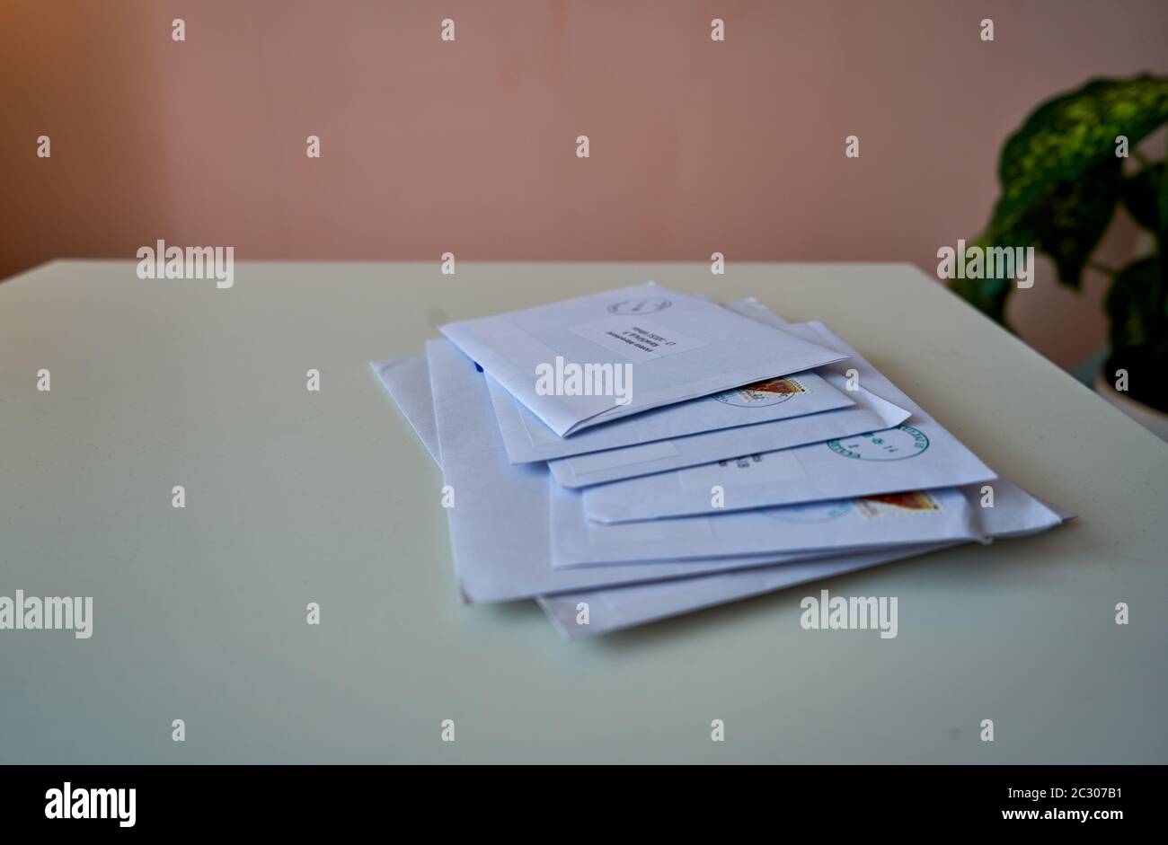 A pile of envelopes with bills on a table Stock Photo