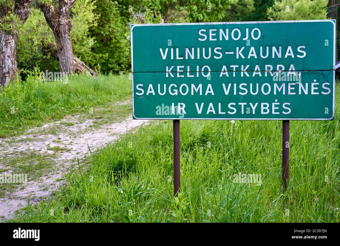 Huge sign near the old road in Vilnius. 'Senojo Vilnius - Kaunas kelio atkarpa saugoma visuomenės ir valstybės' Stock Photo
