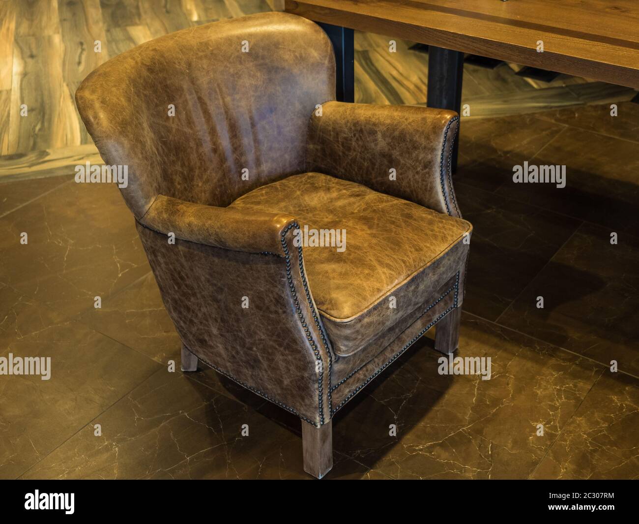 A beautiful leather armchair stands in the lobby of the Rosa Khutor hotel Stock Photo