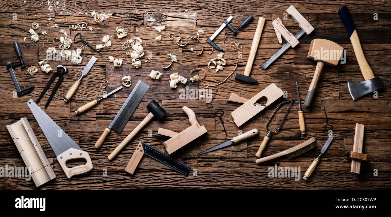 Various Carpenter Tools From Toolkit Laying On Desk Stock Photo