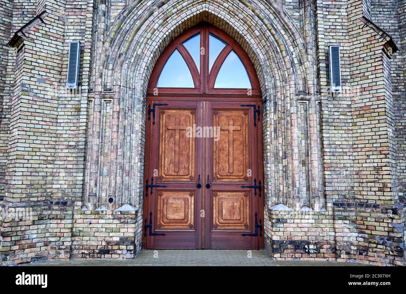 Huge old wooden door in church Stock Photo