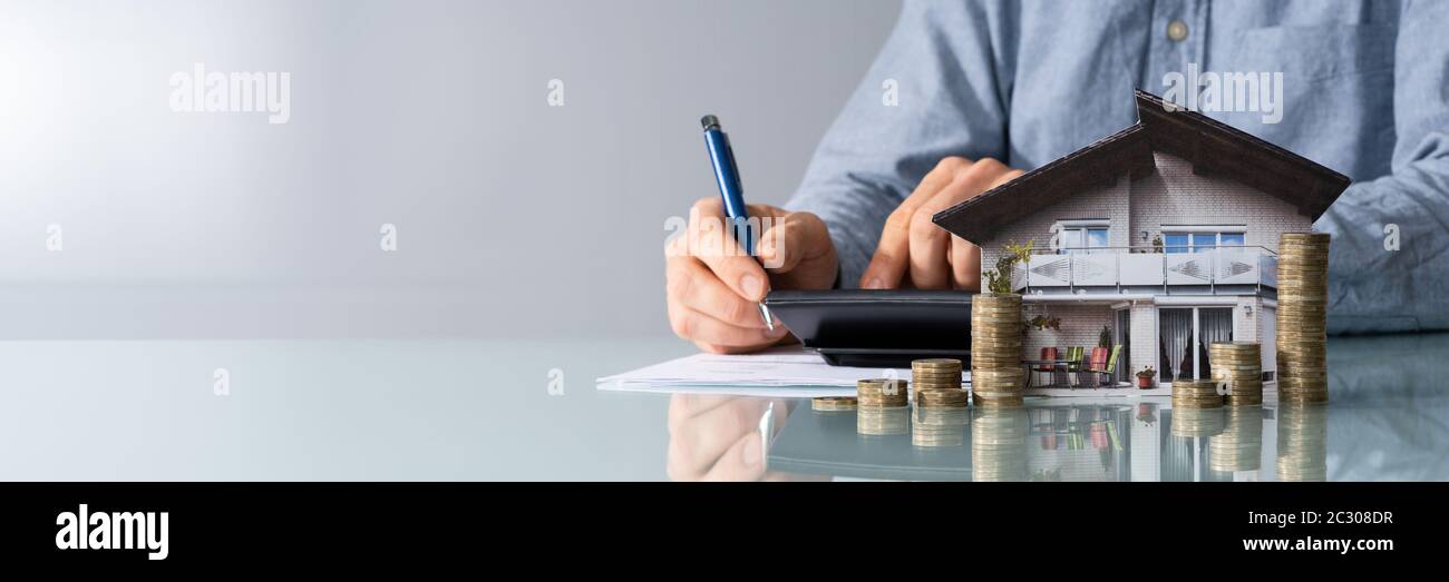 Businessman calculating tax house hi-res stock photography and images ...