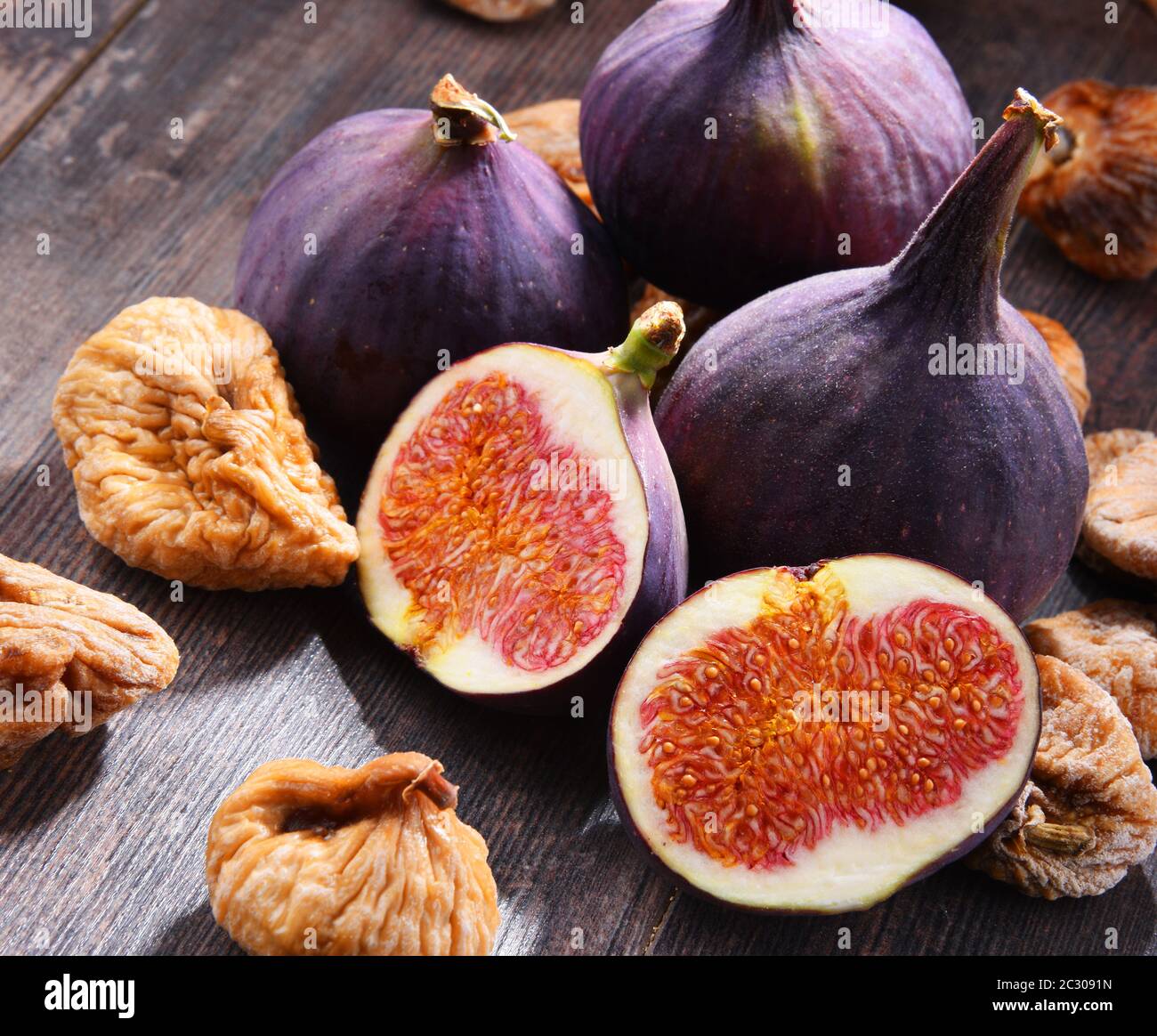 Composition with fresh and dried figs on wooden table Stock Photo - Alamy