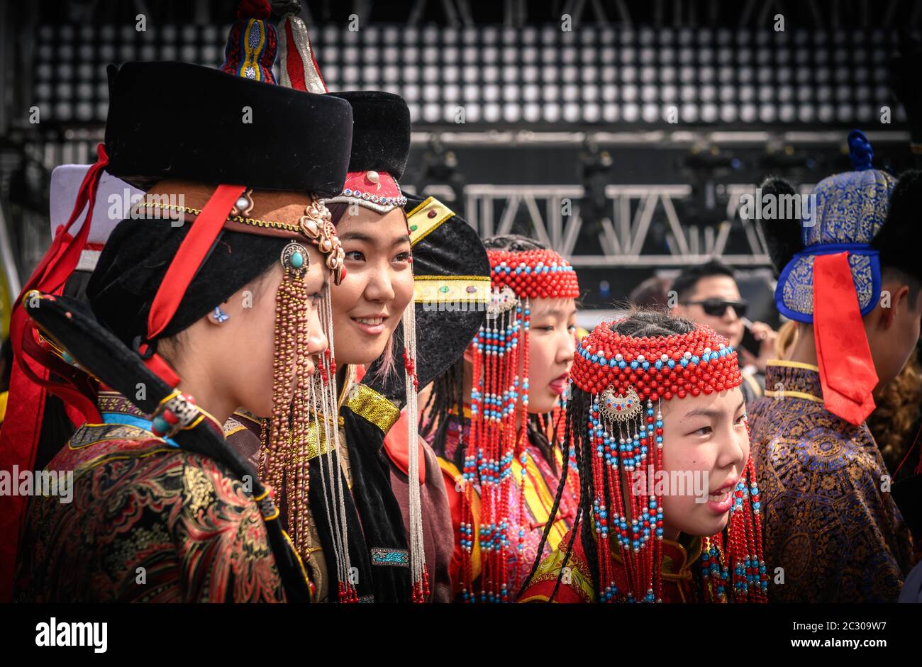 Young ladies in Mongolian traditional costumes at the Central square, in the DEEL (national dress) festival, Ulaanbaatar capitol city, Mongolia Stock Photo