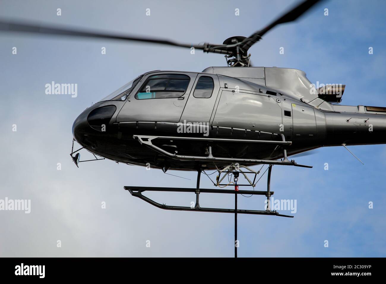 A cargo helicopter on the railway construction site KÃ¶then, mast transport Stock Photo